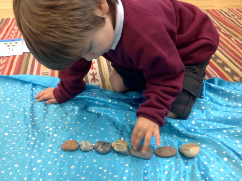 Pupil sorting pebbles 
