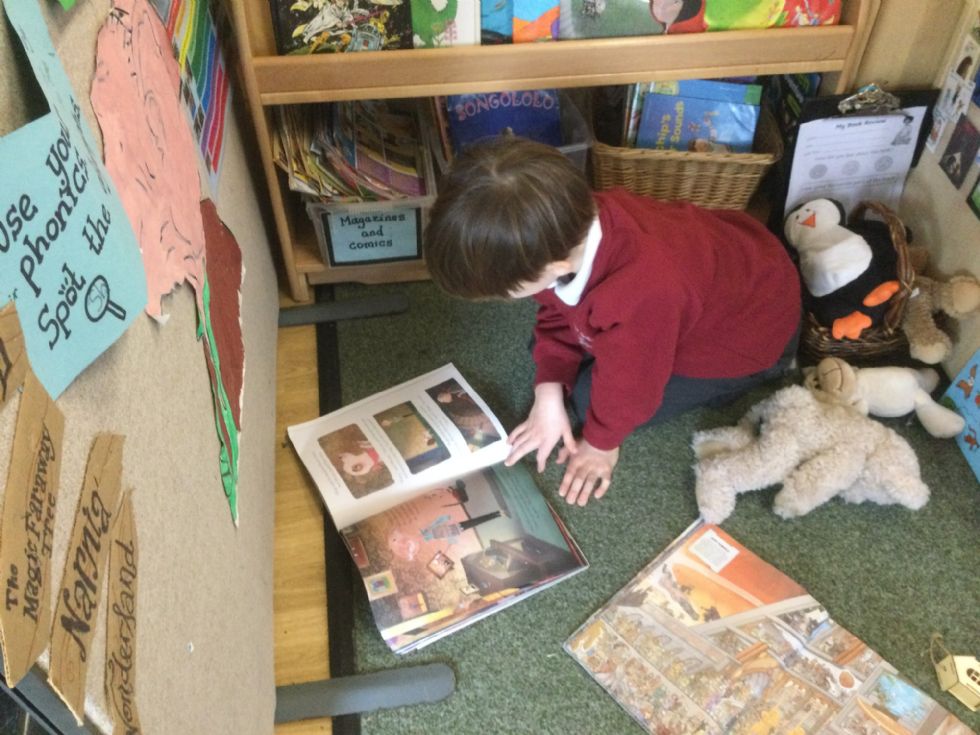  Boy reading in book corner